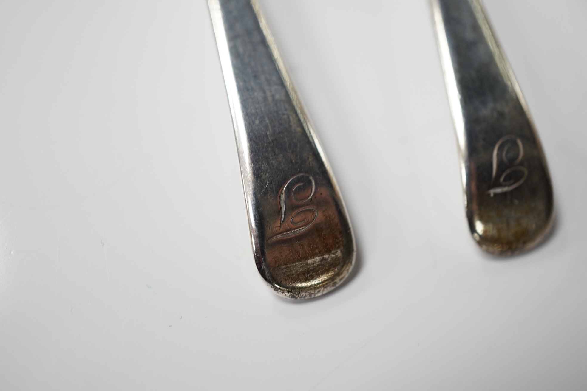 A pair of George III silver cauldron salts, London, 1765, with a pair of later Georgian mustard ladles, together with a late Victorian silver sauceboat. Condition - fair to good